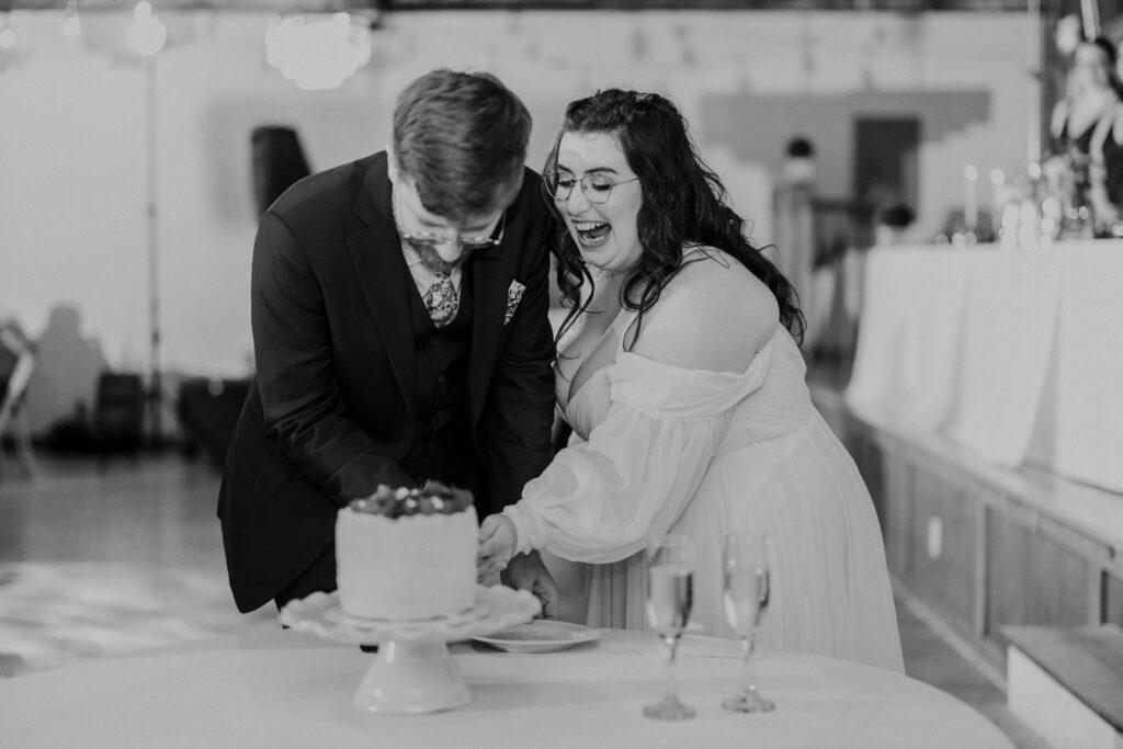 Bride and groom cutting cake at their Kansas City wedding. 