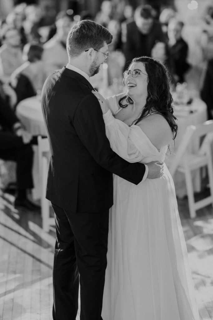 Bride and groom slow dancing in front of guests at their  Kansas City wedding reception. 