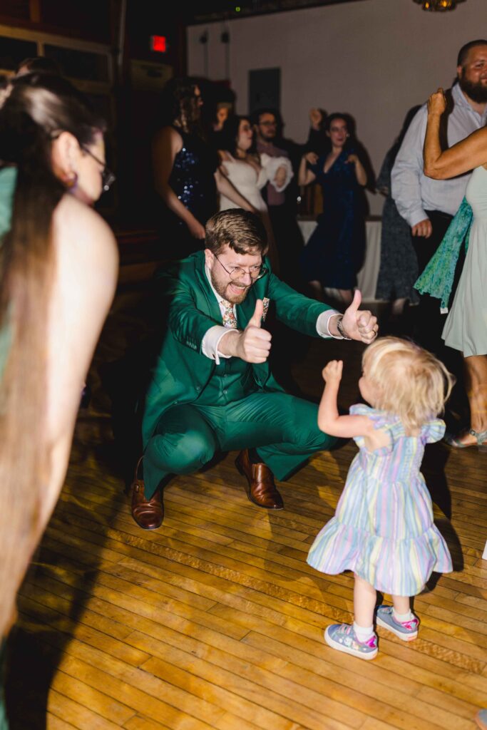 Groom and guests dancing with a child at the Kansas City wedding.