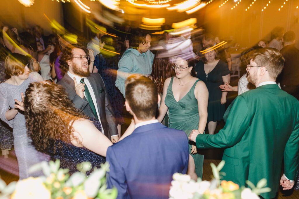 Wedding guests dancing during the wedding reception at The Magnolia Brookside.