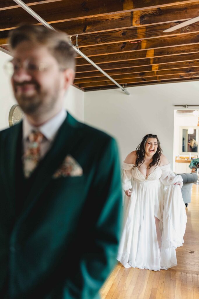 Bride giggling behind the groom before their first look at The Magnolia Brookside.