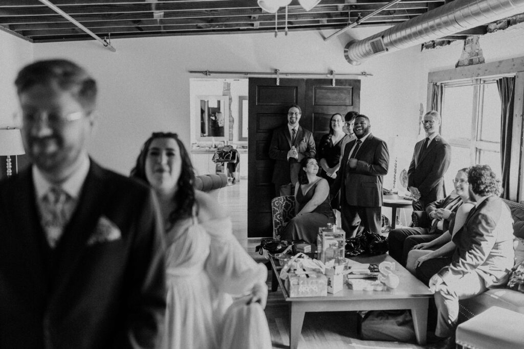 Bride and groom about to have a first look while their best friends watch.