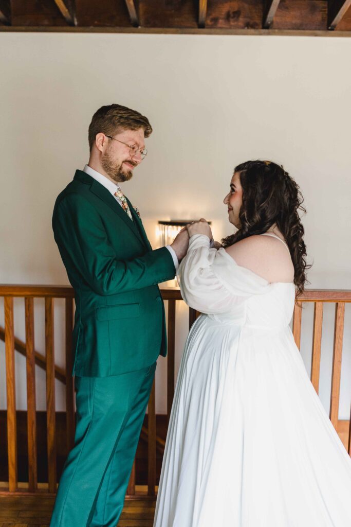 Groom holding the brides hands during their first look.