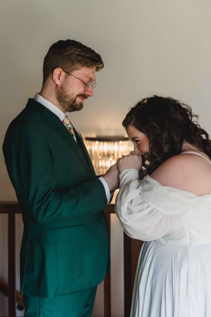 Groom holding back tears as the bride kisses his hands at The Magnolia Brookside.