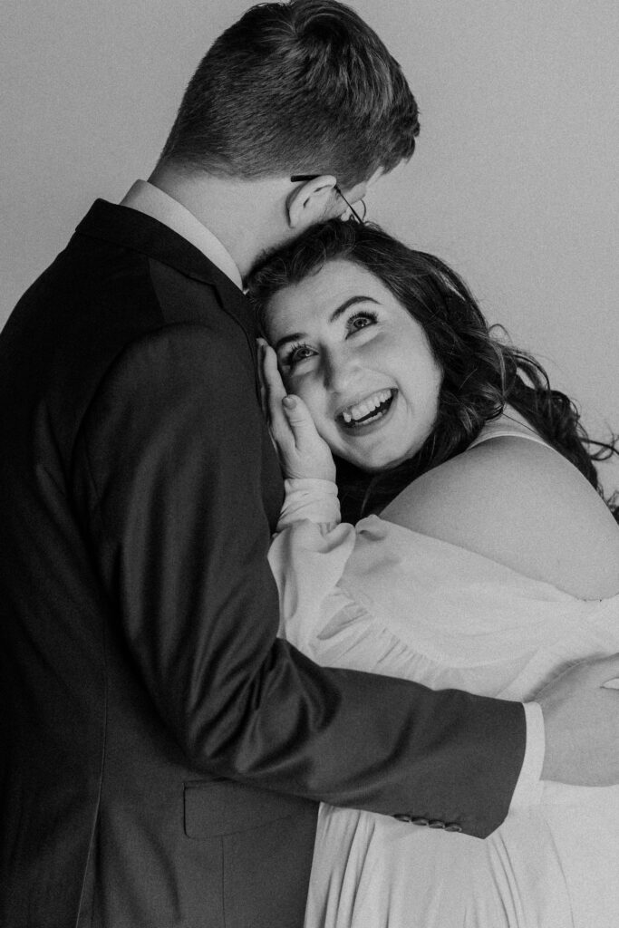 Bride and groom hugging while crying during their first look.