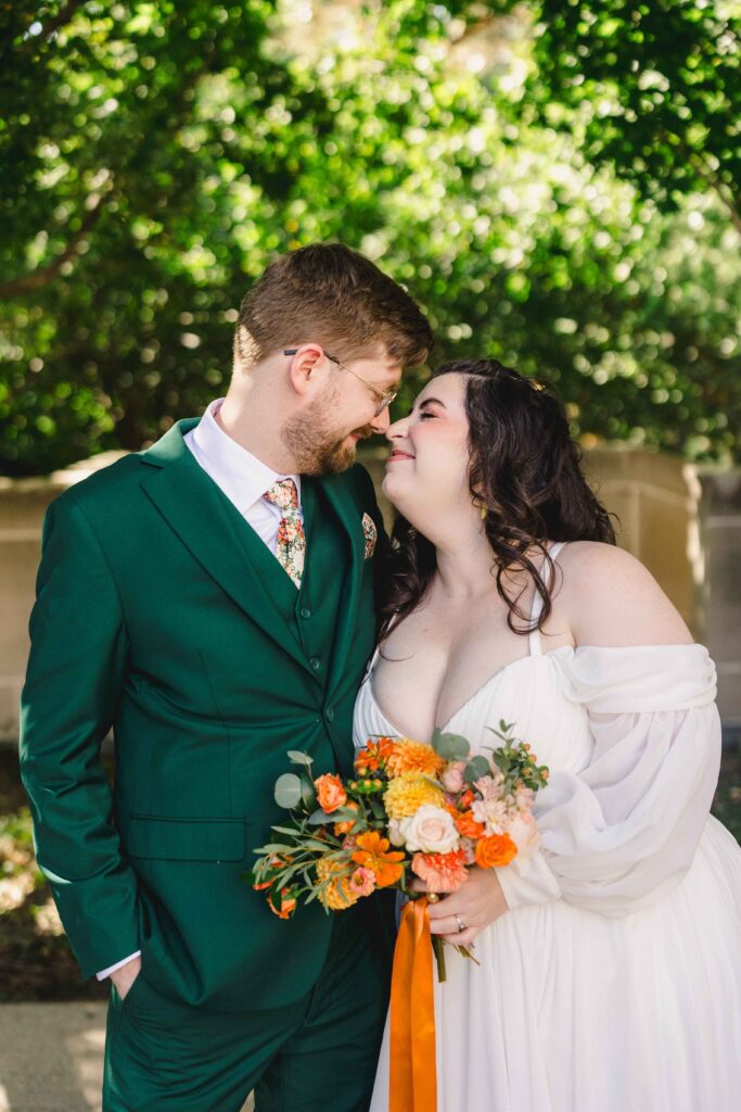 Bride and groom rubbing noses during wedding portraits. 