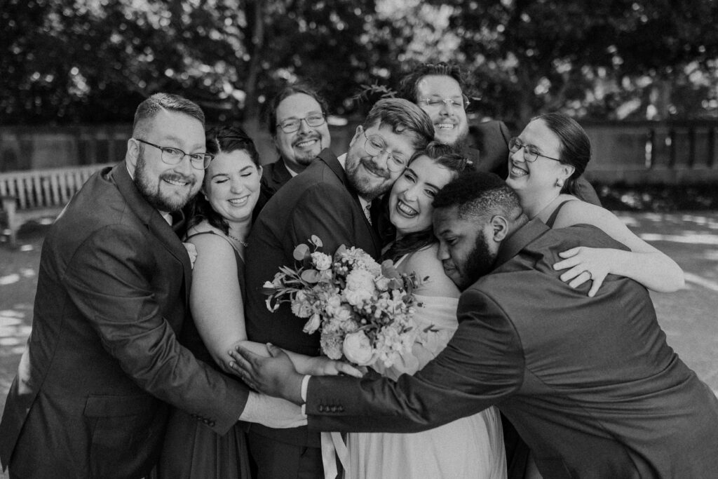 Bridal party having a big group hug.