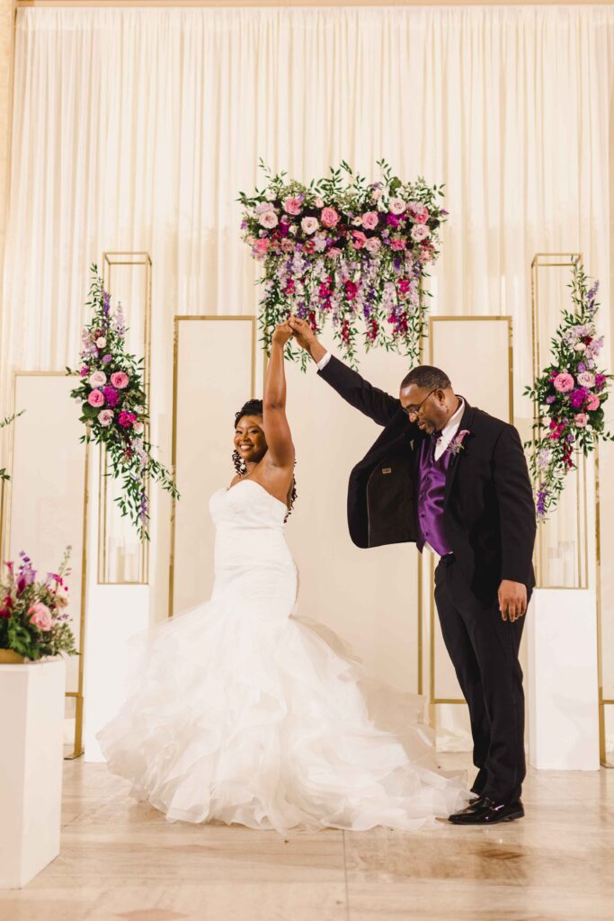 Groom spinning his bride around.