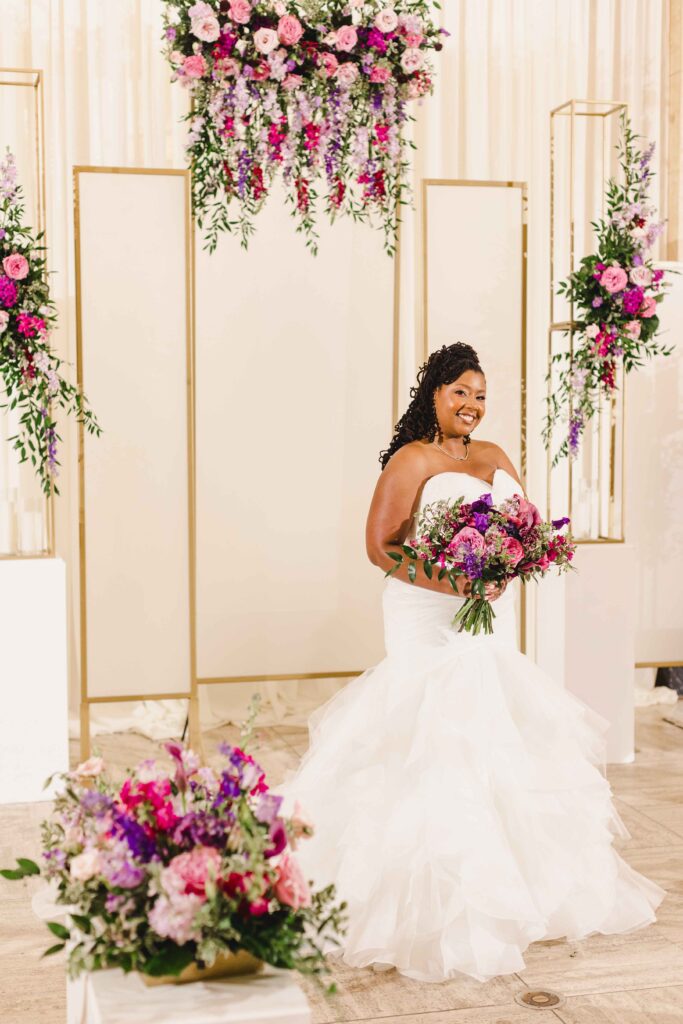 Bridal portrait of the bride surrounded by elegant wedding flowers.