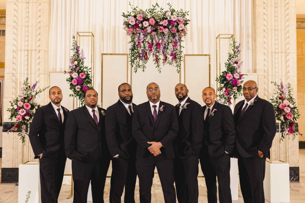 Groom and groomsmen taking a group picture.