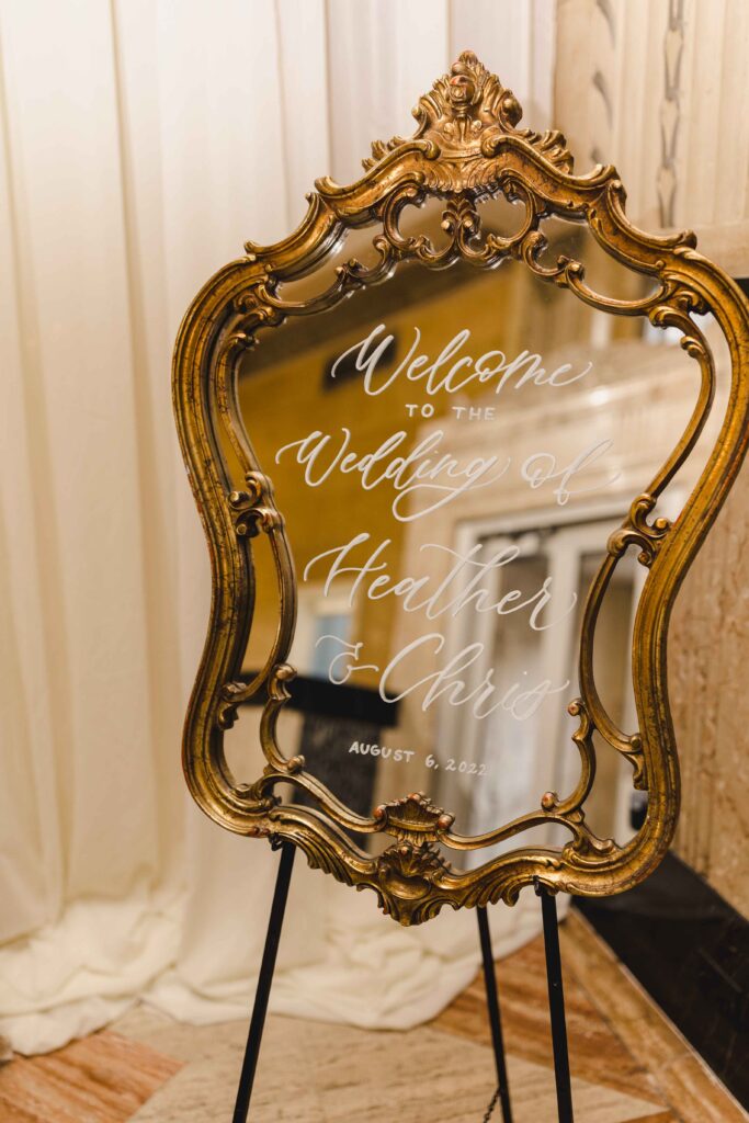 Welcome sign on a gold mirror at the Kansas City wedding.