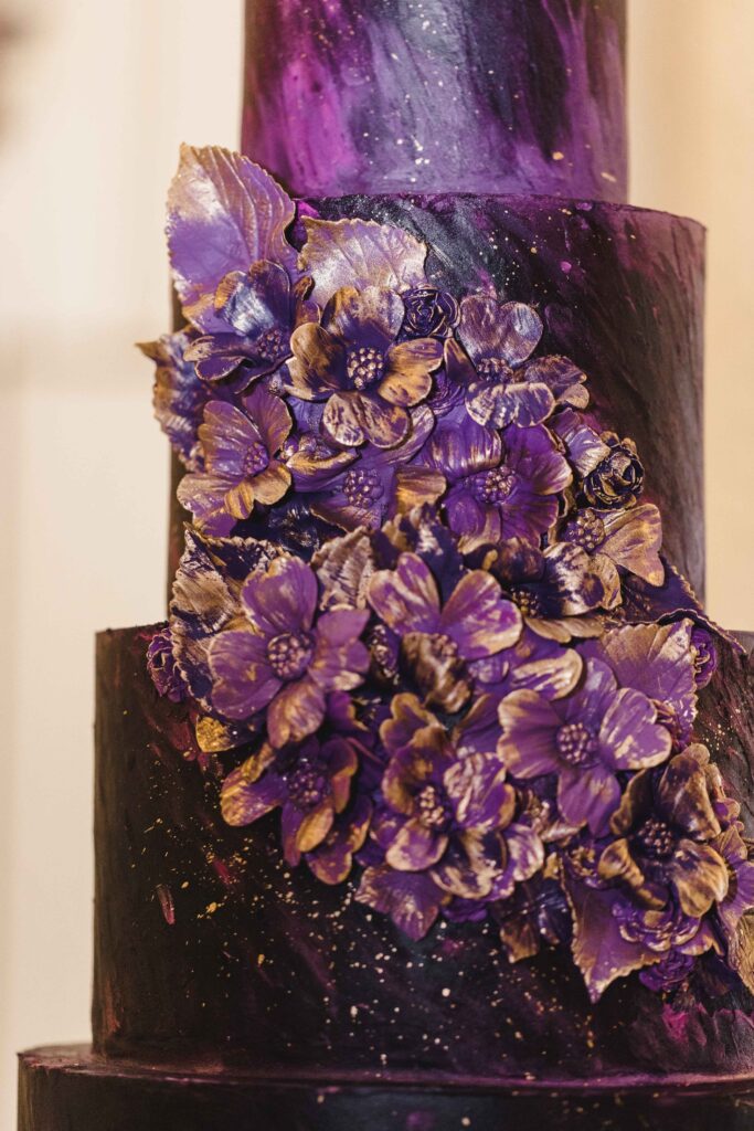 Custom cake with purple and gold details at the Kansas City wedding.