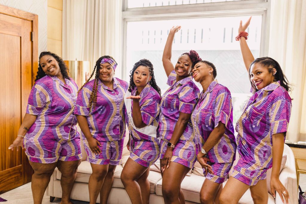 Bride and bridesmaids doing a silly pose after getting ready.