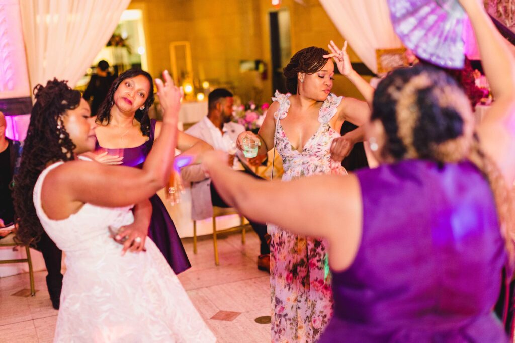 Bride dancing with guests at the lively wedding reception at The Grand Hall at Power & Light.