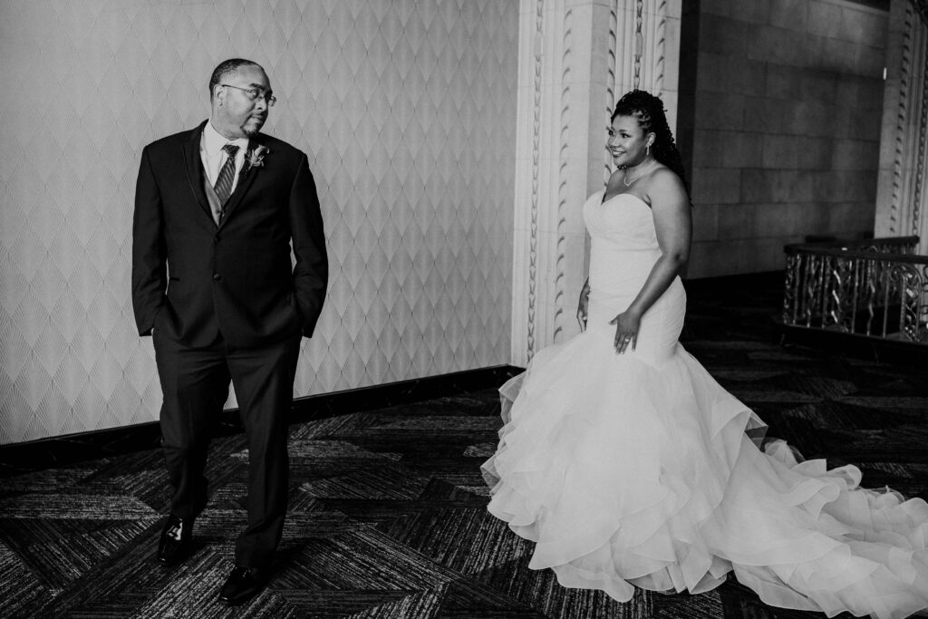 Groom turning around to see his bride during their first look moment.