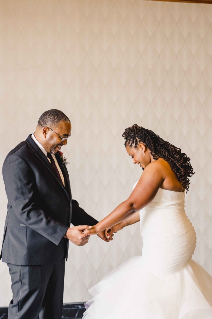 Bride and groom taking each other in during their first look at their Kansas City wedding.