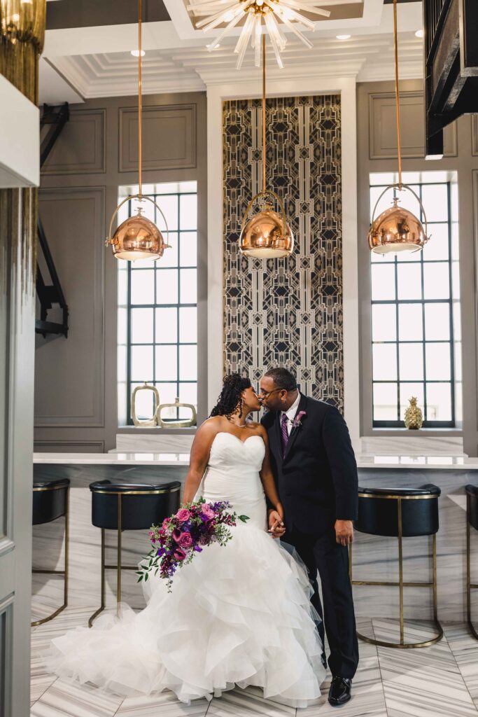 Bride and groom kissing before their elegant Kansas City wedding.