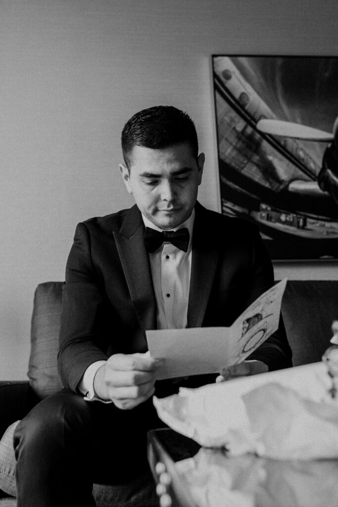 Groom reading a card.