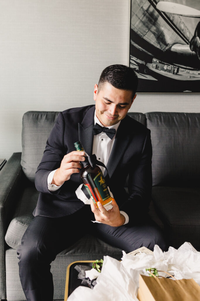 Groom holding a present.