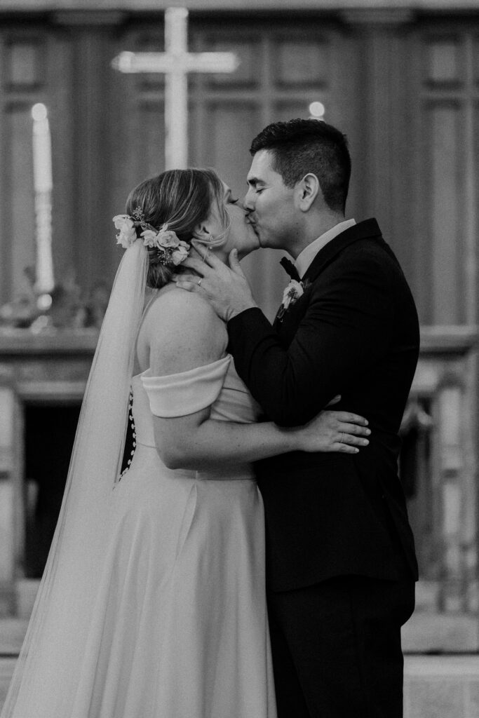 Bride and groom kissing after saying "I do"
