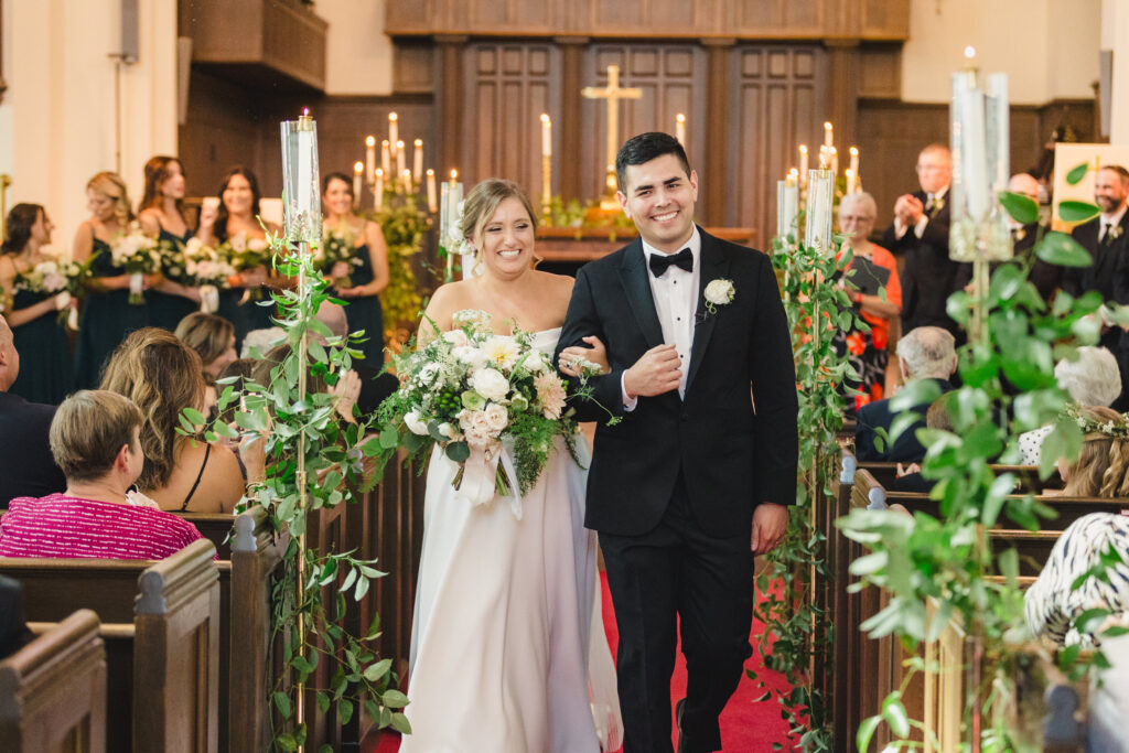 Bride and groom walking down the aisle before their reception at The Guild KC.