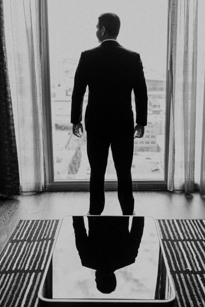 Groom looking out over downtown Kansas City.