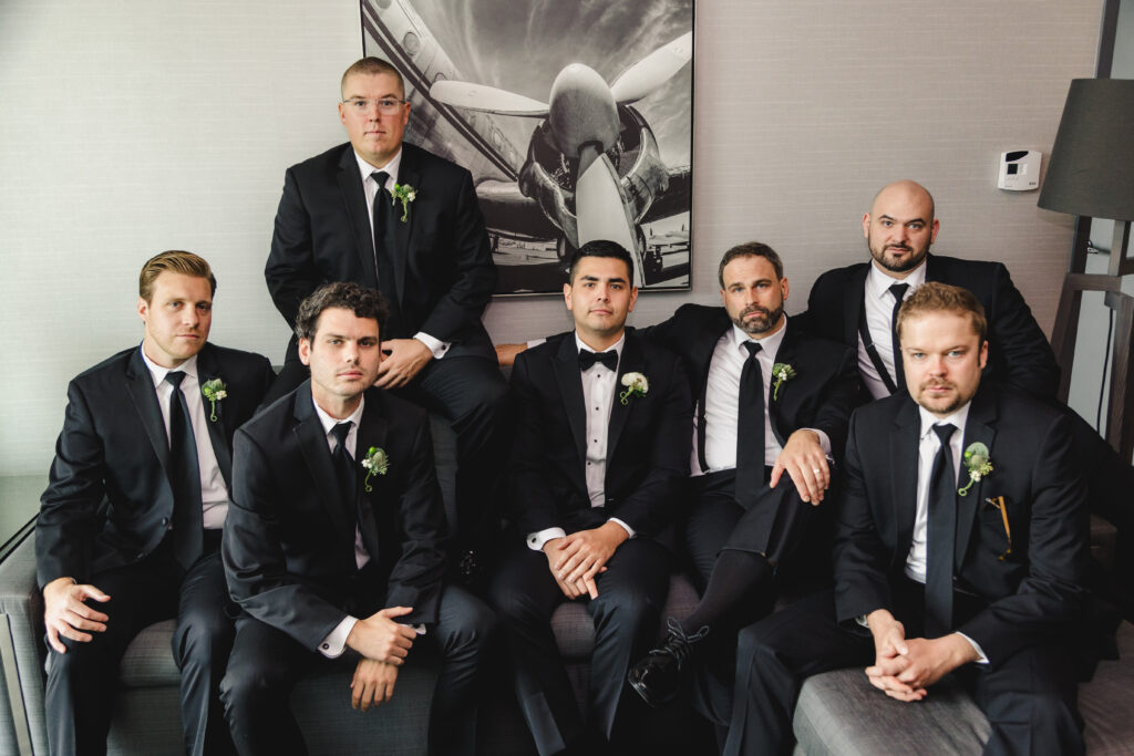 Groom and Groomsmen sitting with serious faces.