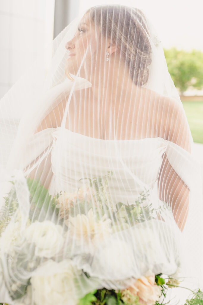 Bride with her veil over her face before she heads to The Guild KC.