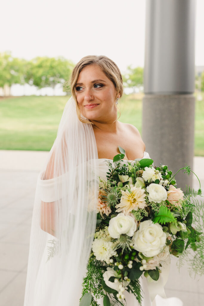 Bridal portrait of the bride holding a big bouquet.