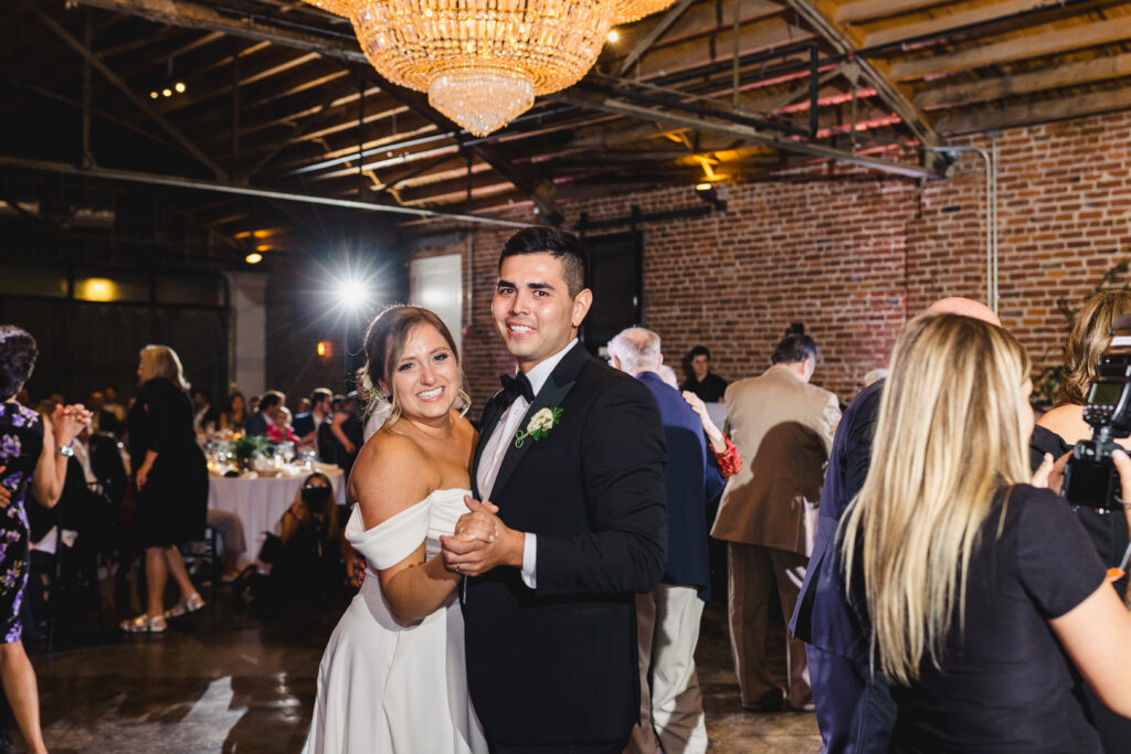 Bride and groom dancing with guests at The Guild KC.