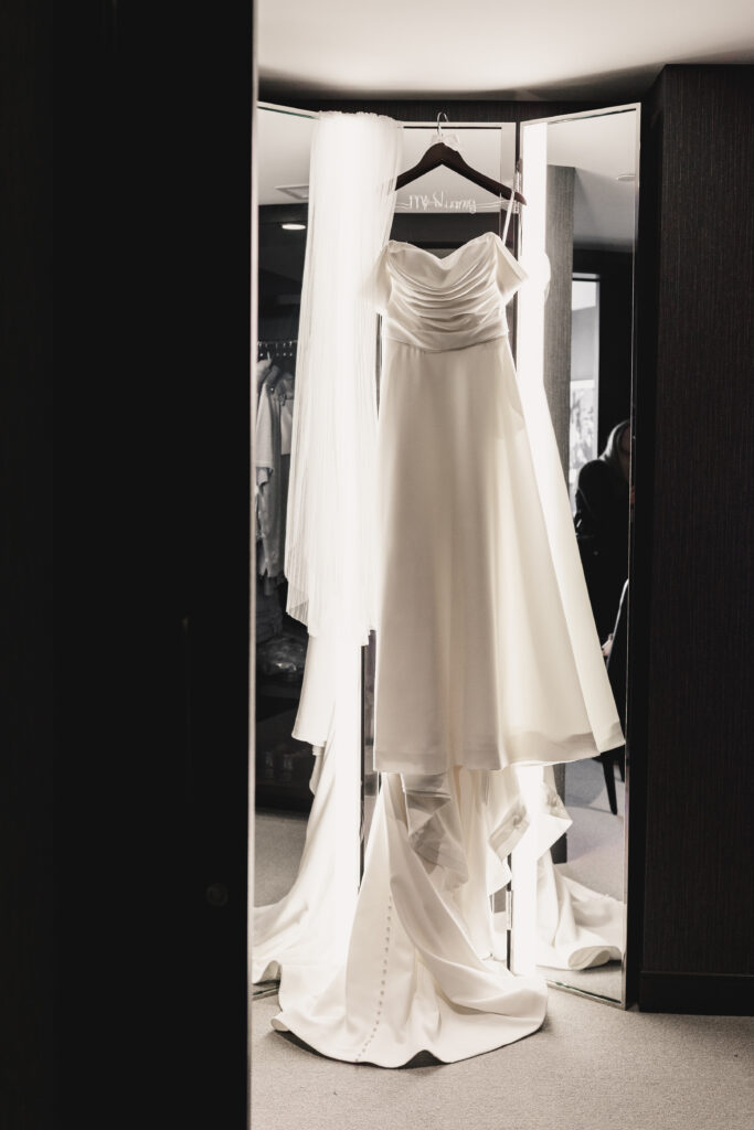 Bride's wedding gown hanging up.