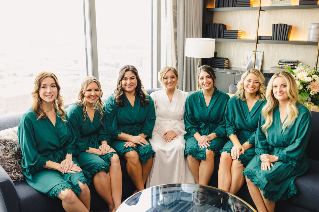 Bride and bridesmaids sitting in robes before the wedding at The Guild KC.