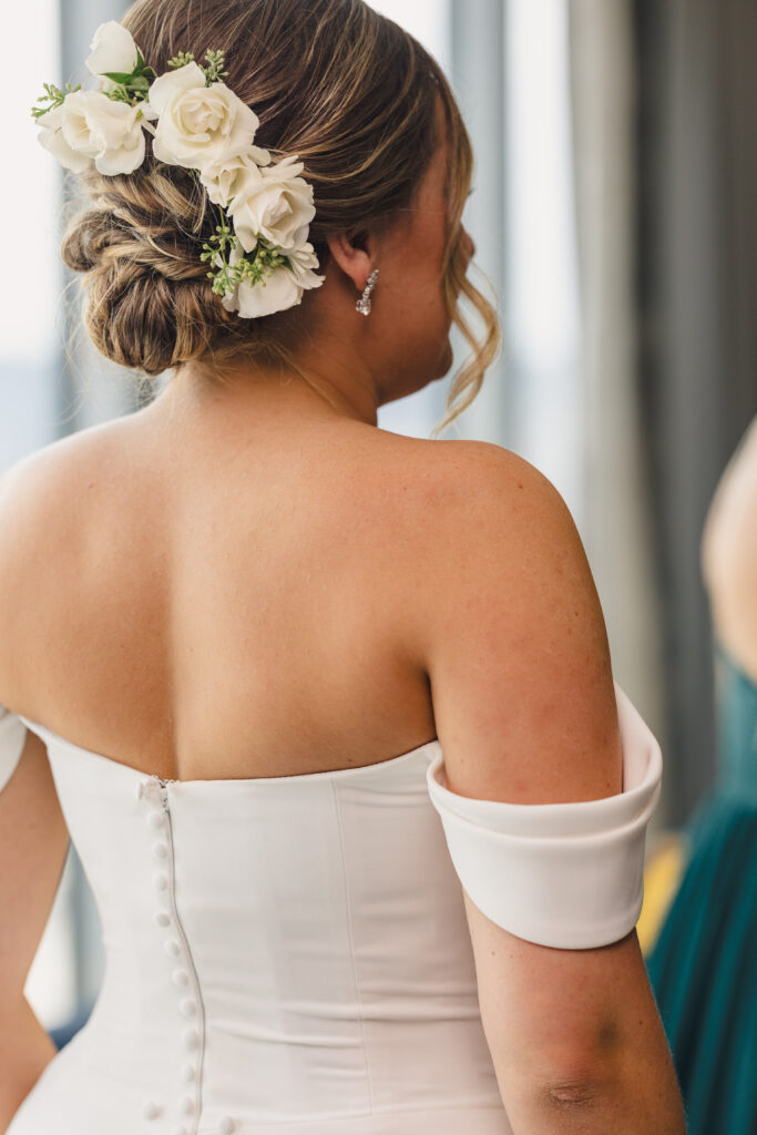 Bride's hair in a bun with flowers.