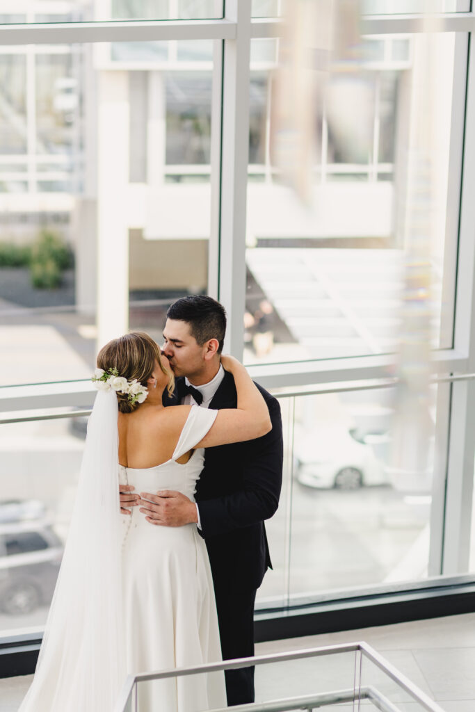 Groom kissing his bride passionately.