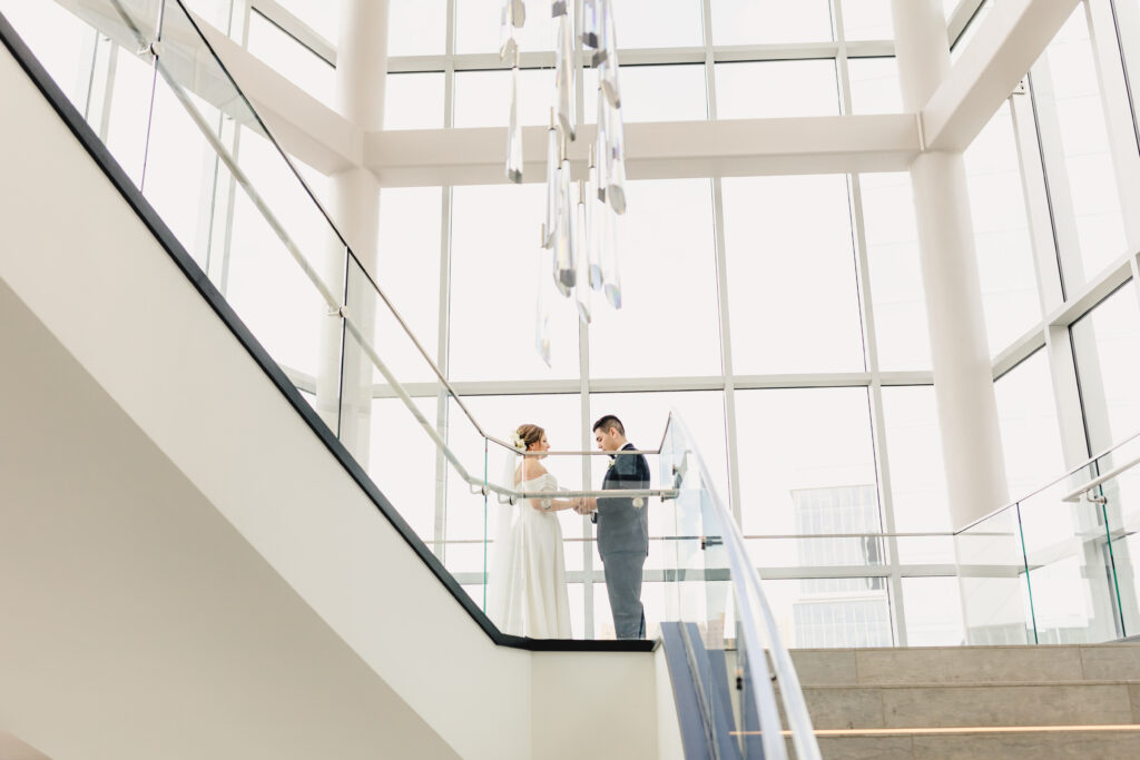 Bride and groom in the stairwell of Loews Kansas City Hotel.