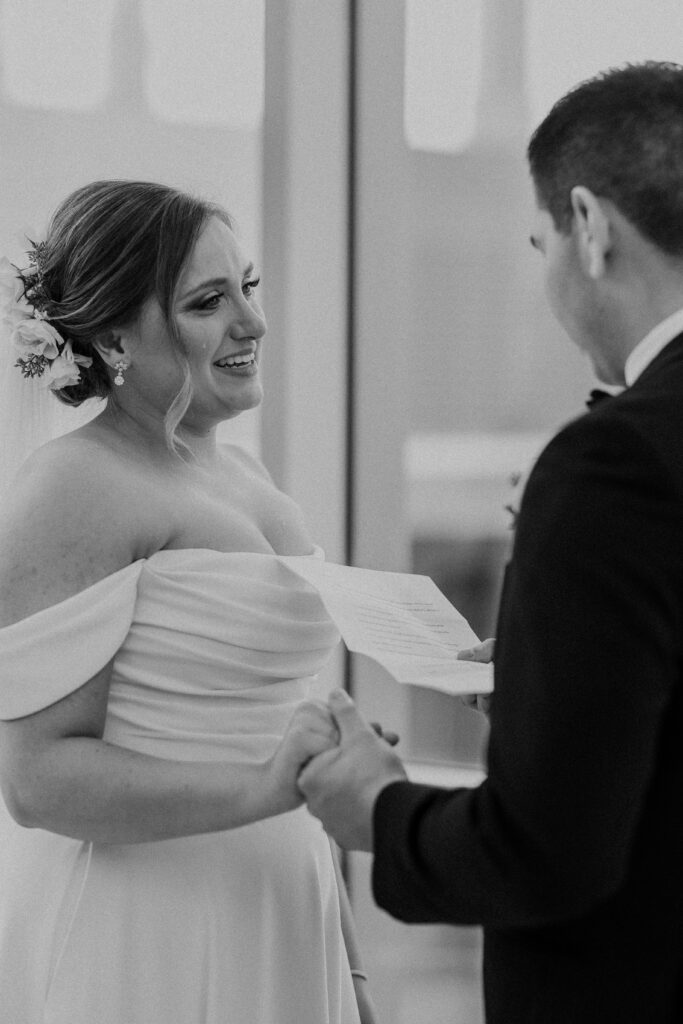 Bride crying as the groom reads his vows before their reception at The Guild KC.