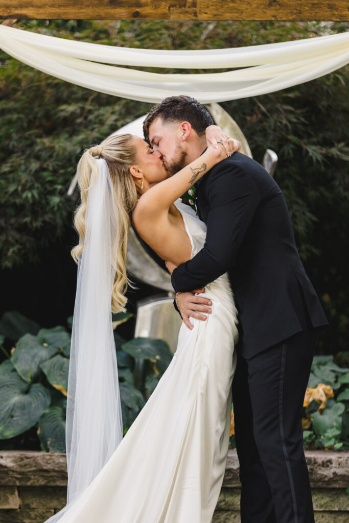 bride and groom first kiss