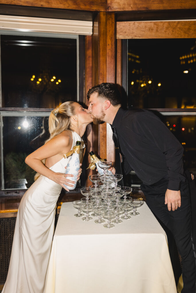champagne tower with bride and groom