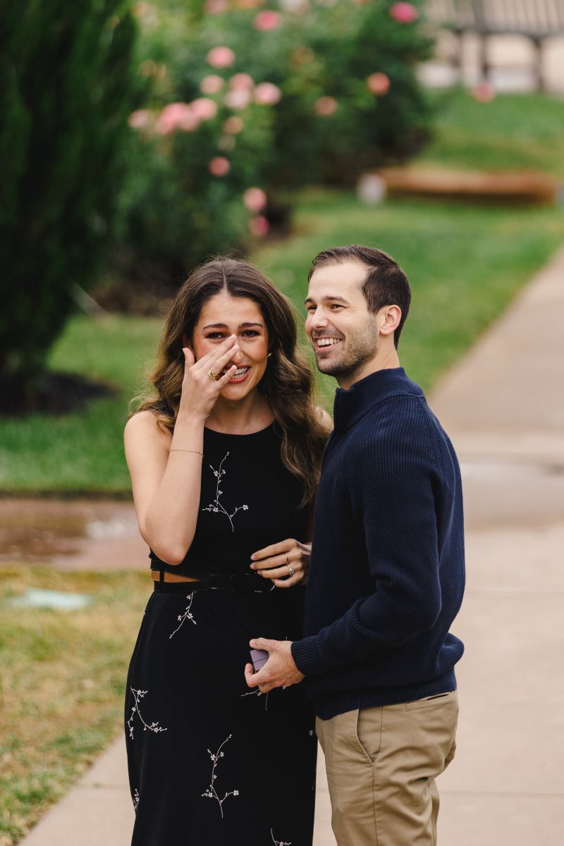 a couple smiling and emotional after a surprise proposal