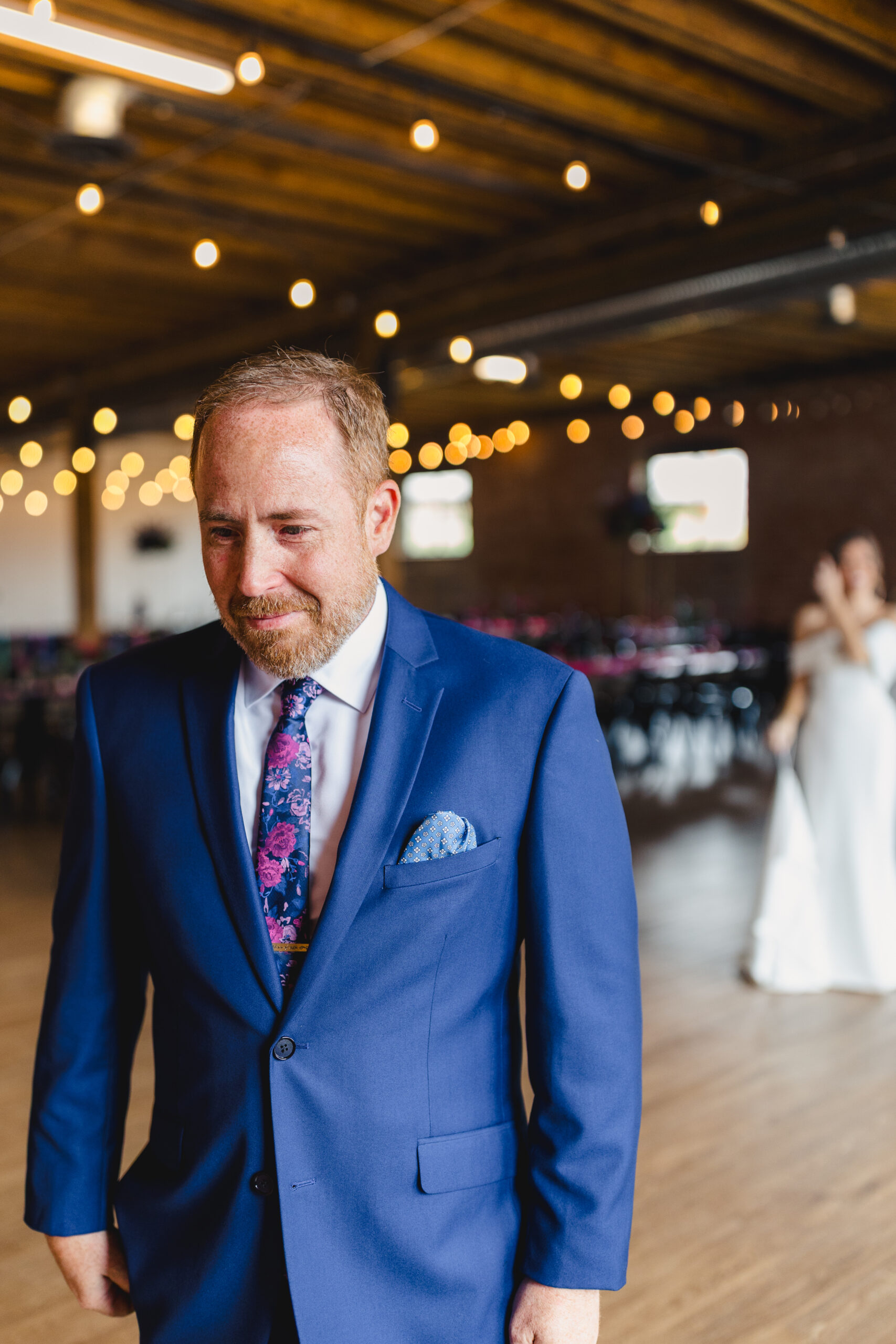 a father waiting to share a first look with his daughter on the day of her wedding 