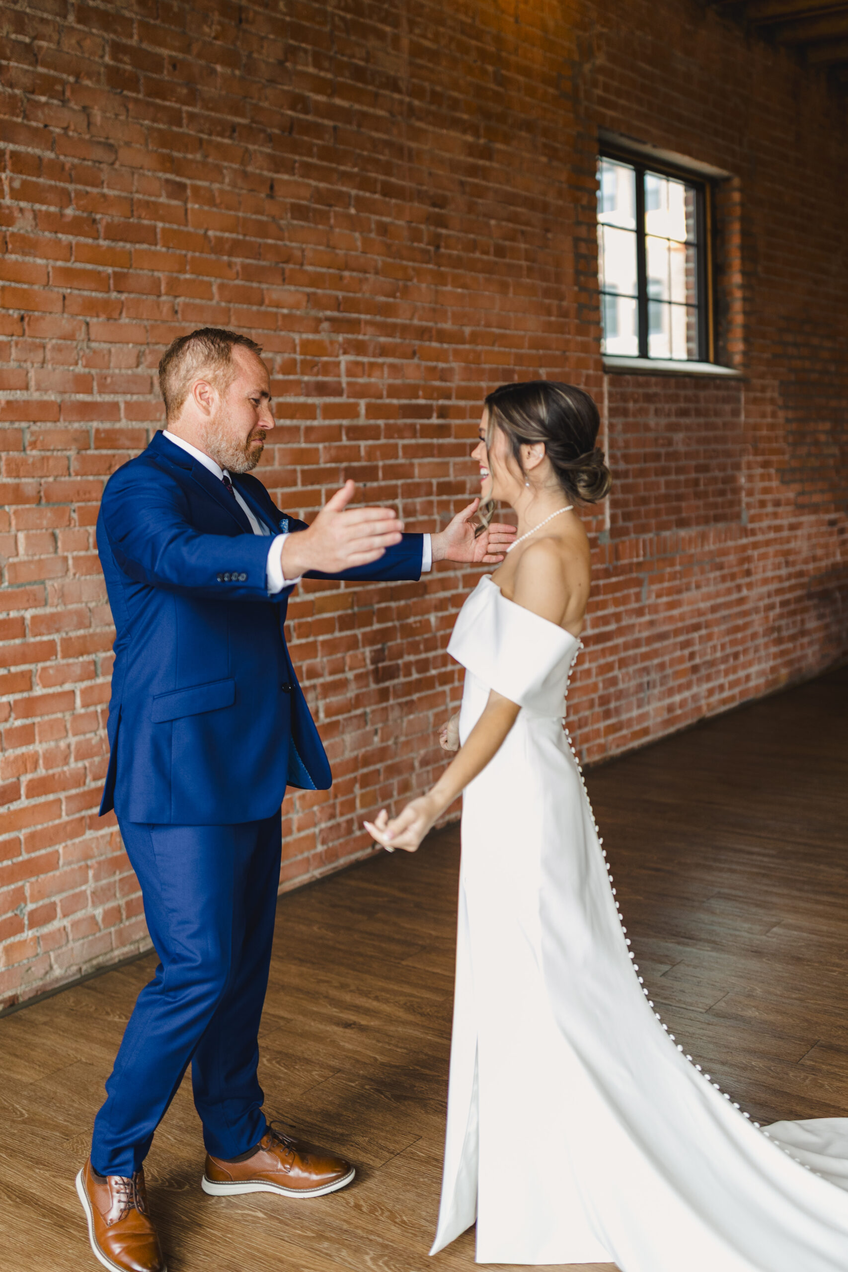 a father sharing an emotional first look with his daughter inside of union event space in kansas city 