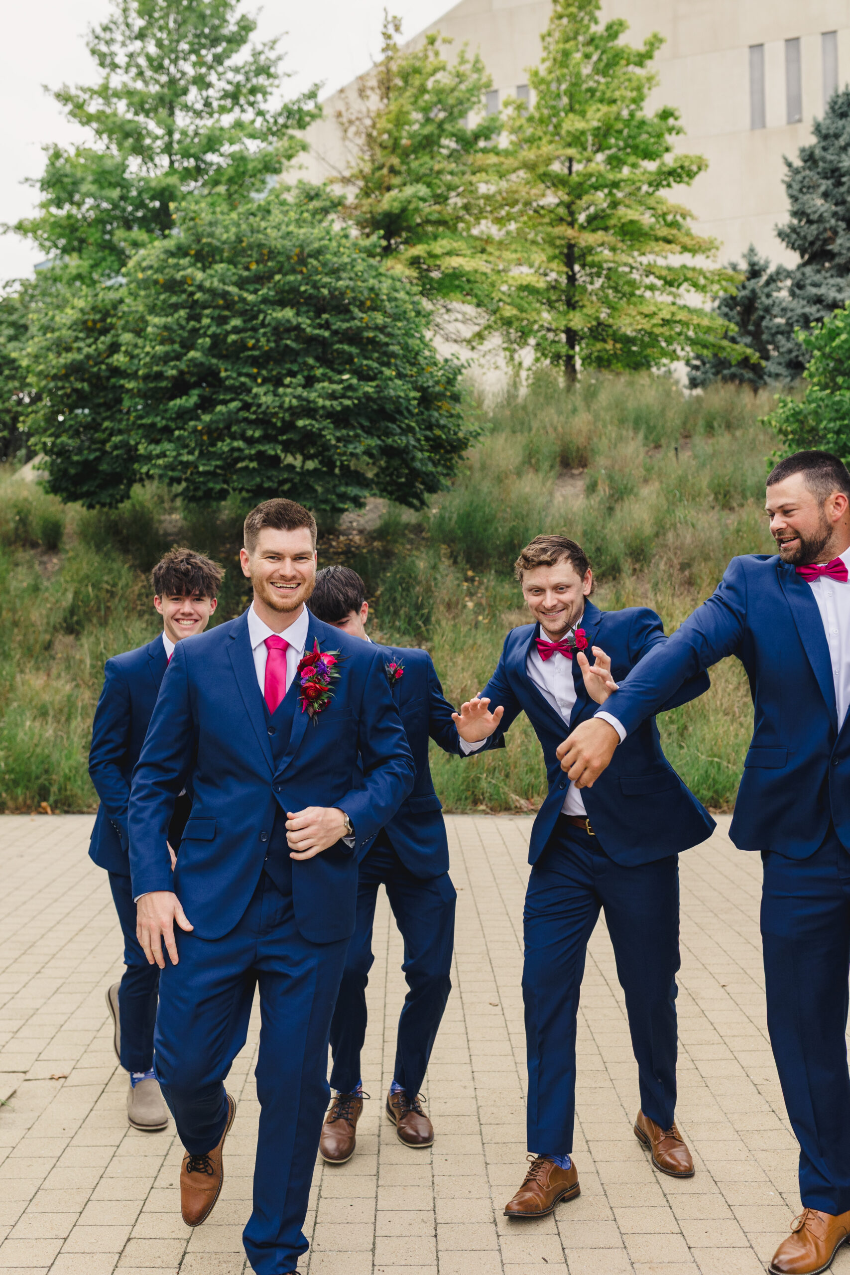 a groom laughing with his groomsmen 
