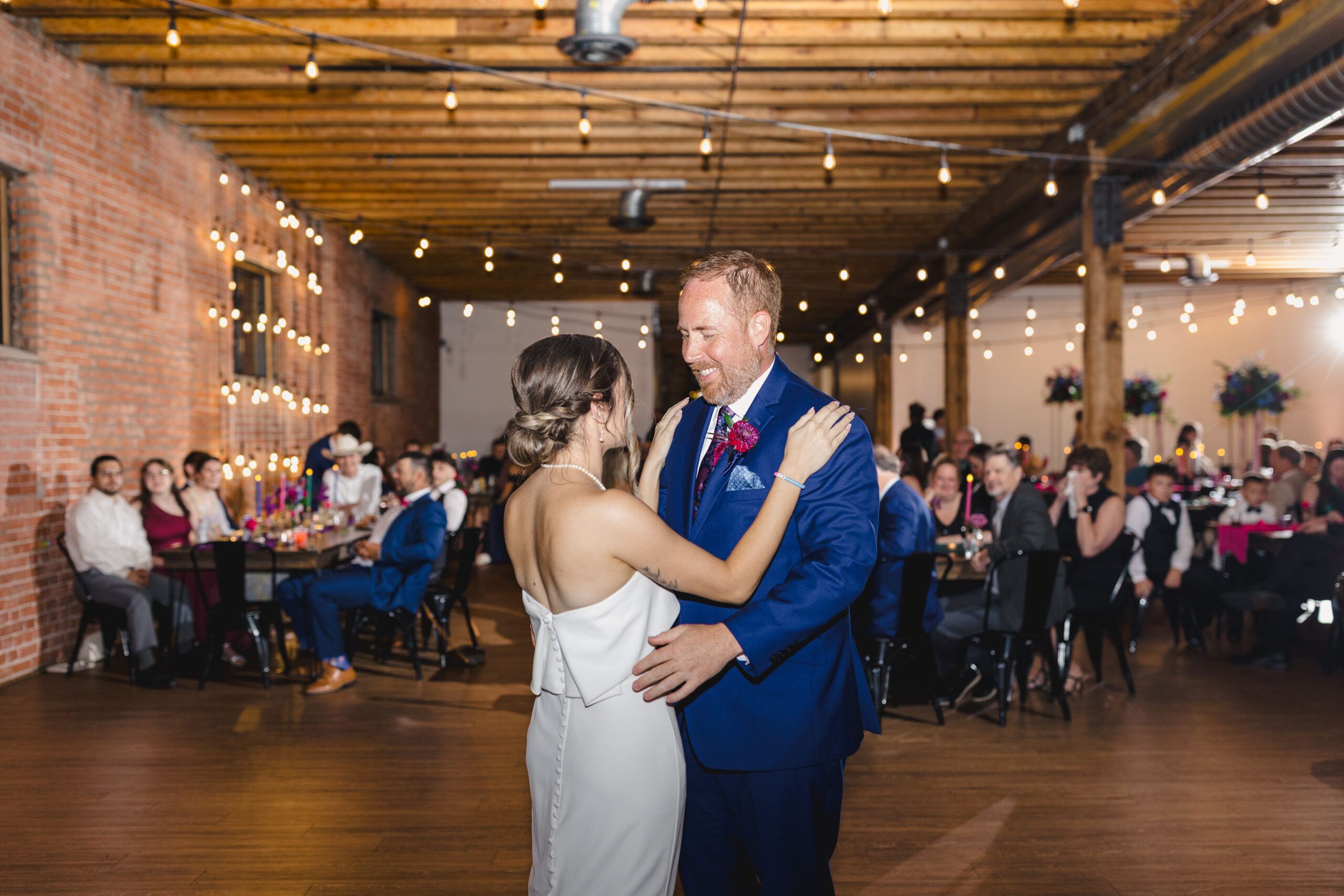 a father and daughter sharing a first dance together 