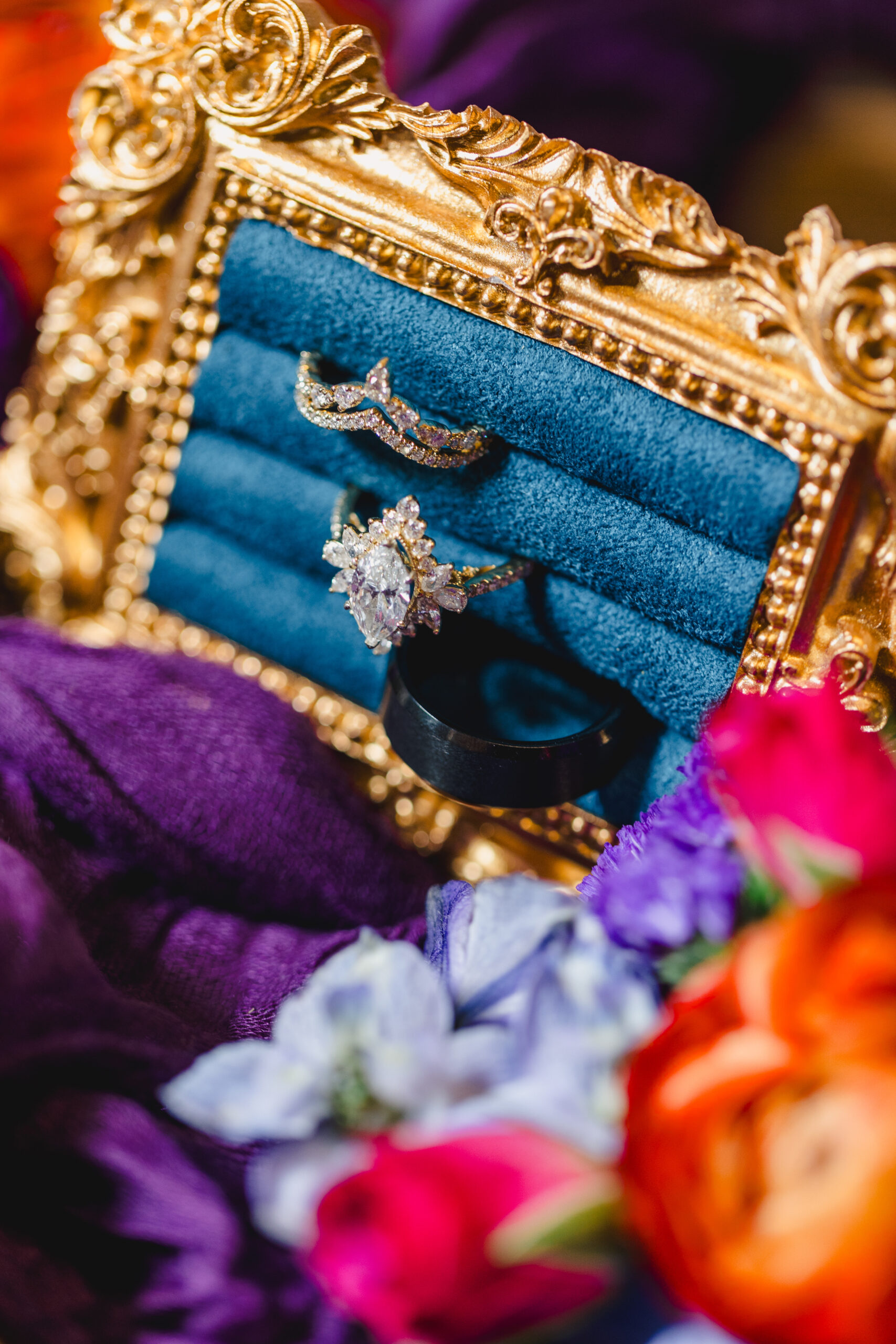 a close up of diamond wedding rings on top of a purple cloth 