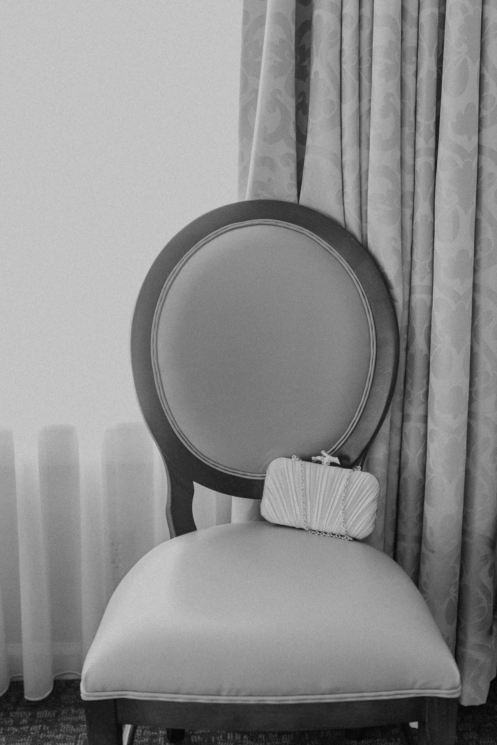 a chair in an elms hotel room in kansas city with a white clutch resting on top of it 
