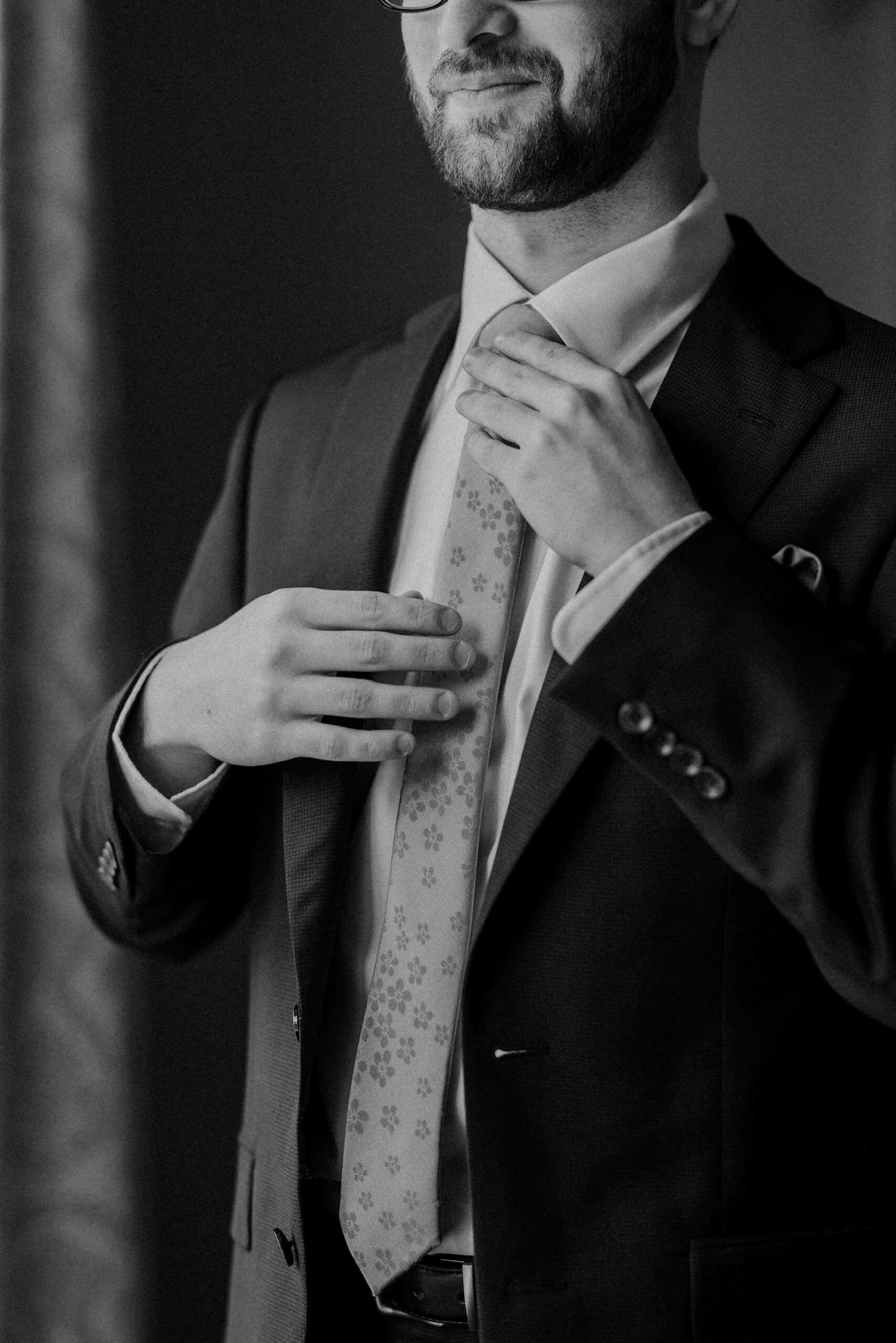 a man adjusting his tie 