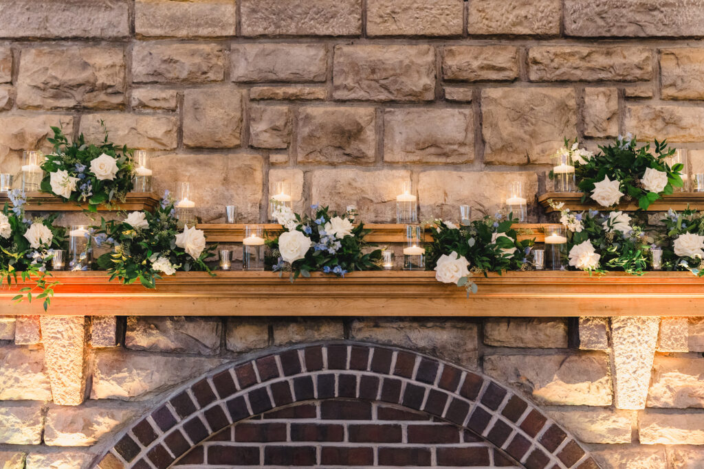 the fireplace at the elms hotel in kansas city decorated with candles and flowers 