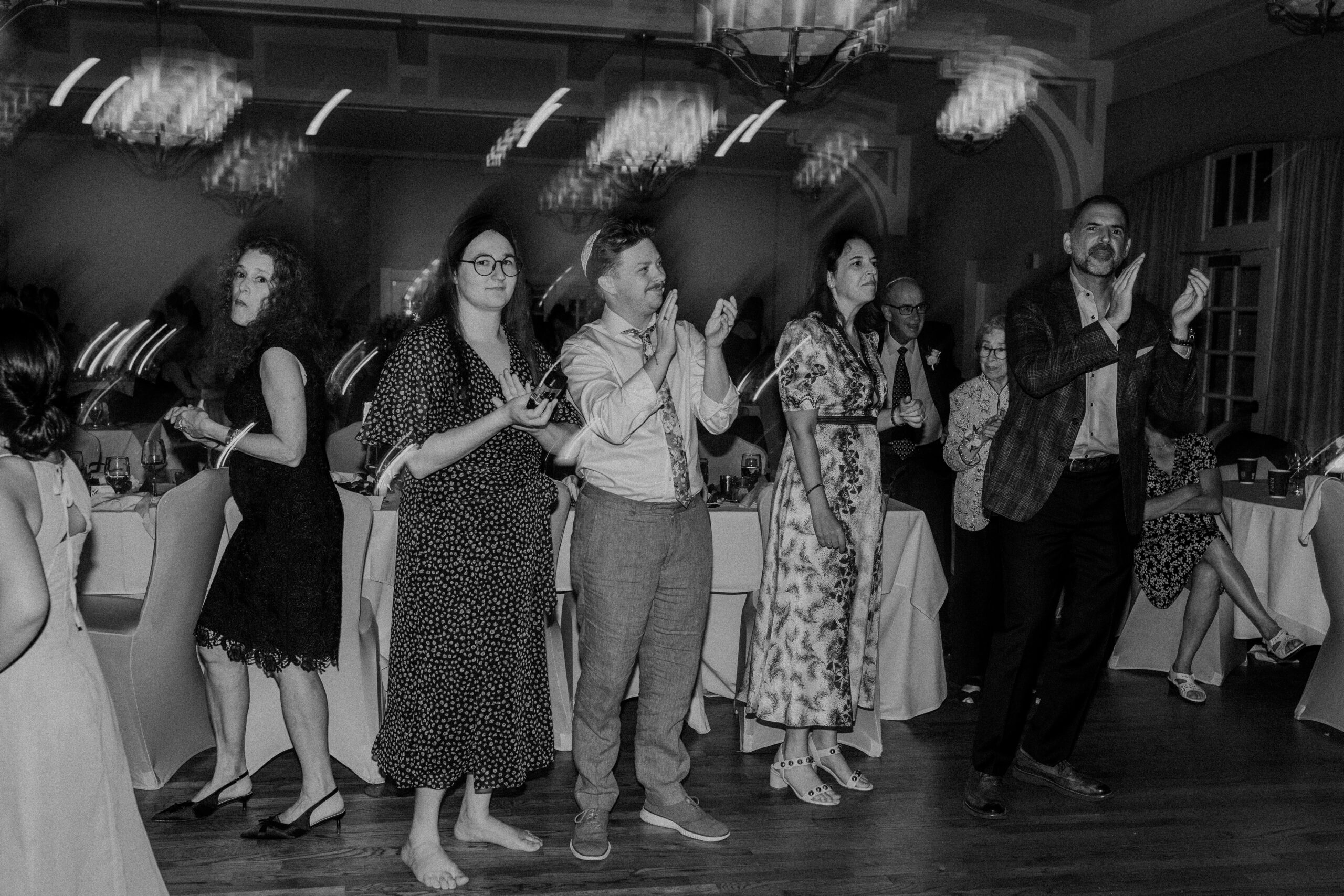 wedding guests clapping and dancing at a wedding reception 