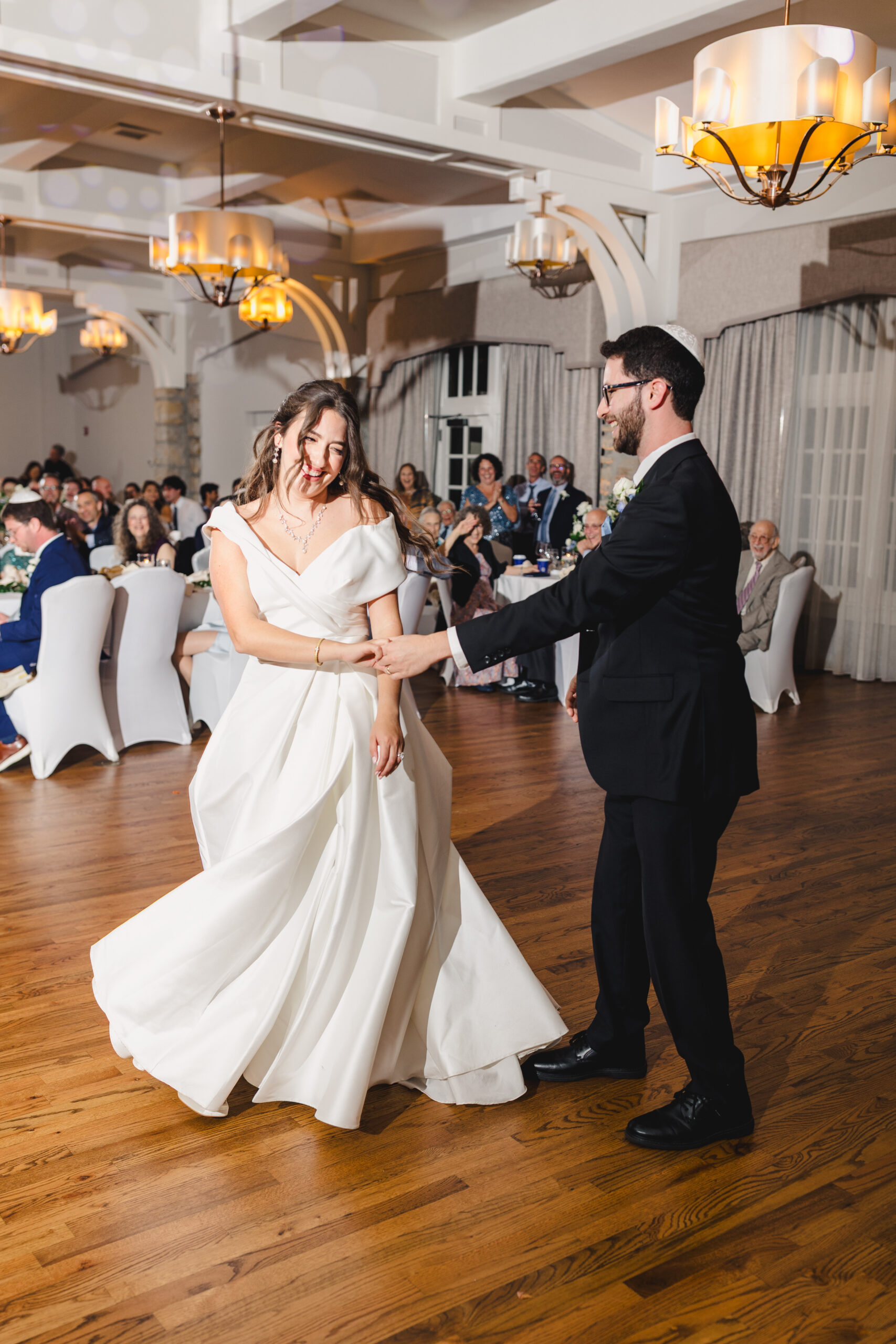a couple dancing with each other at their wedding reception at the elms hotel in kansas city 