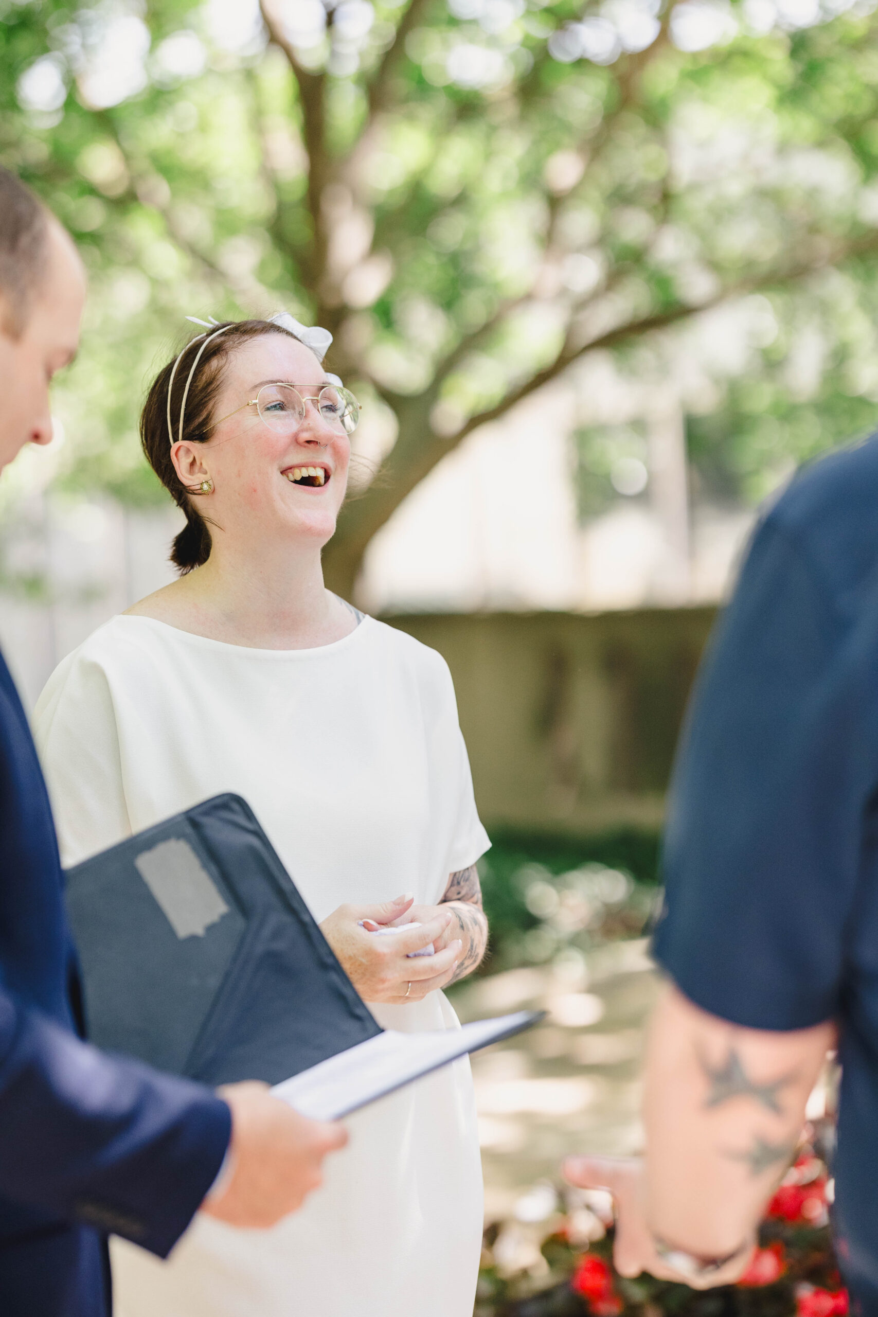 a woman with her officiant and partner on the day of their wedding 